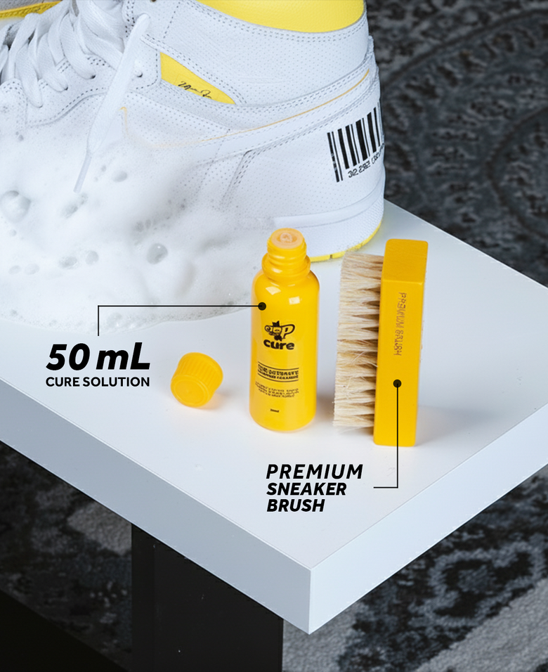 Sneaker care kit with 50 mL solution bottle and brush next to a white sneaker on a gray surface.