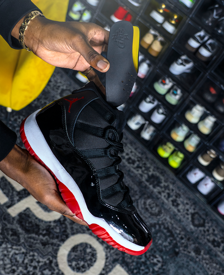 Man Demonstrating Crep Protect Sneaker Guard: Holding a Sneaker in One Hand.