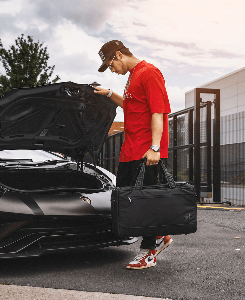 Man confidently holding a Crep Protect sneaker bag in his hand, showcasing the bag's durable design.