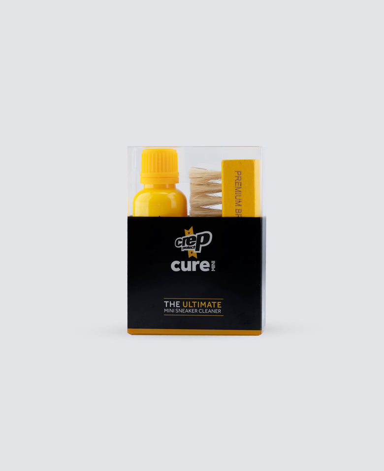 Cigarette lighter and matches in a black box with 'cure!' branding on a white background