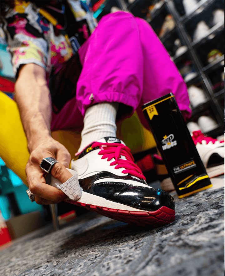 Woman using Crep Protect wipes to clean dirt off her sneakers