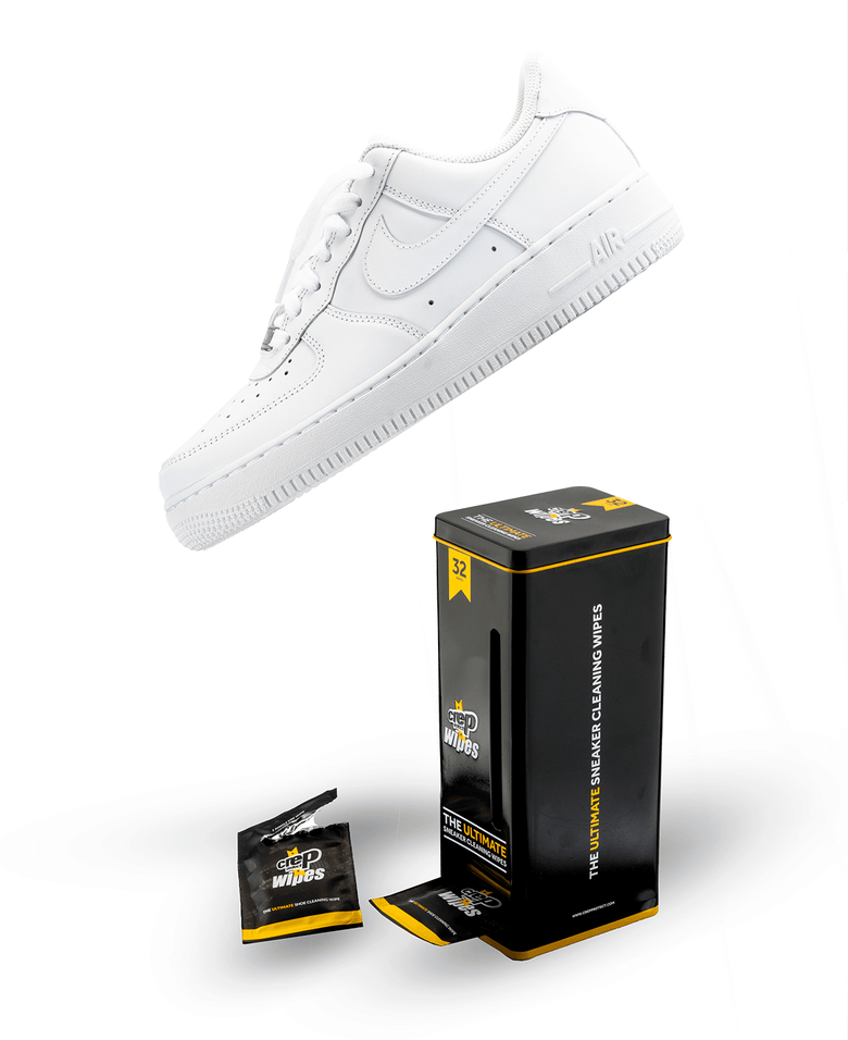 White sneaker paired with cleaning wipes for maintenance.